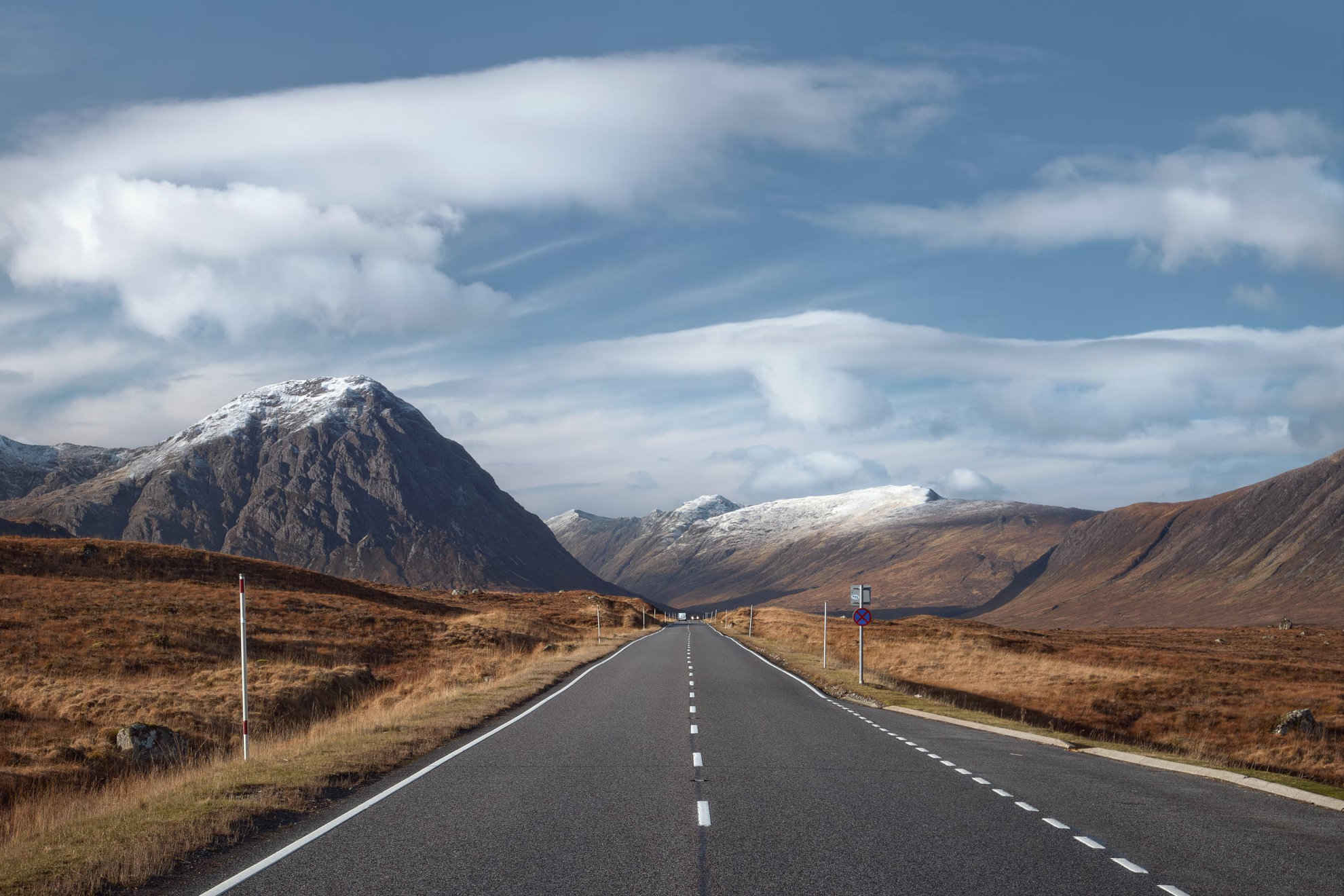 image of a road with a backdrop of mountains