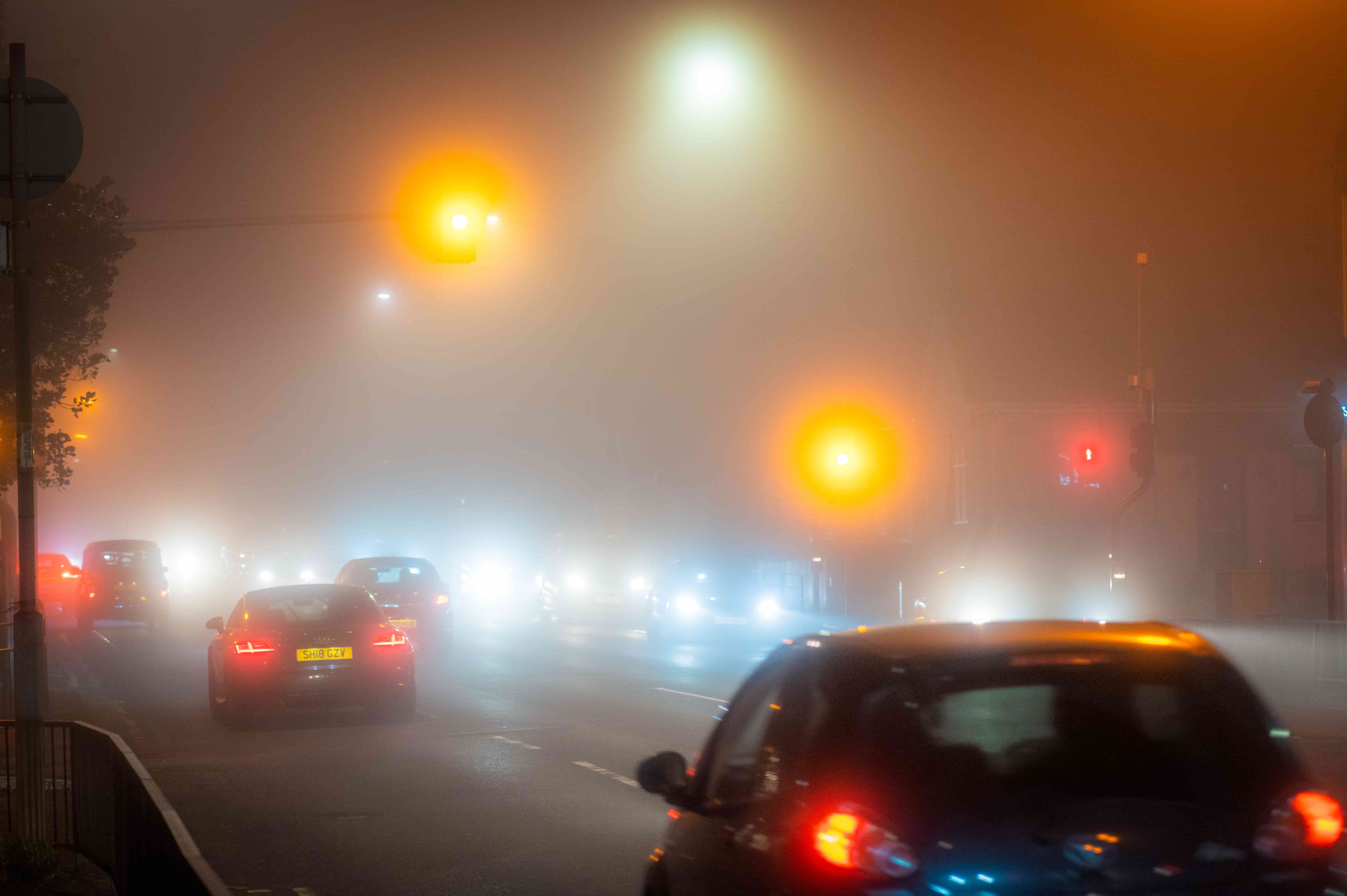 cars driving in fog at night