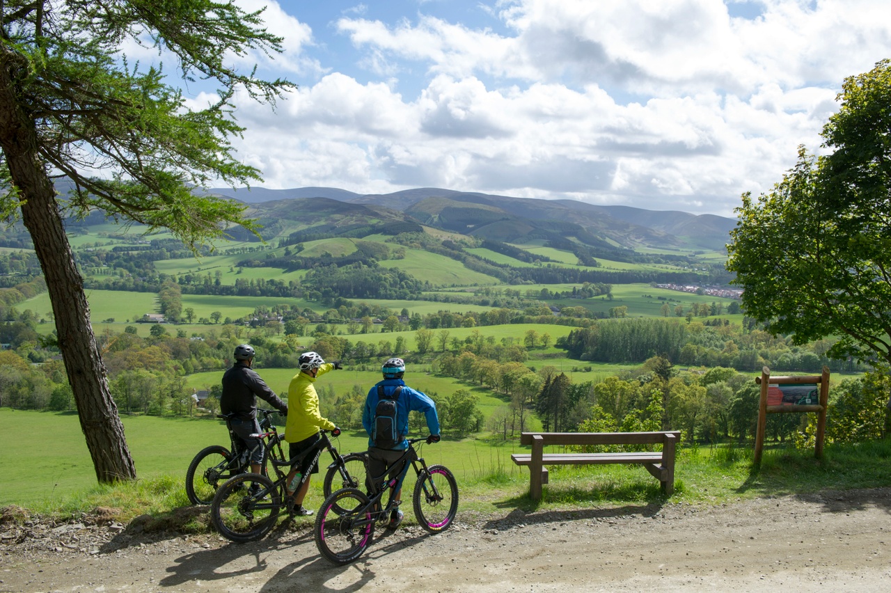Cyclists paused by scenic countryside