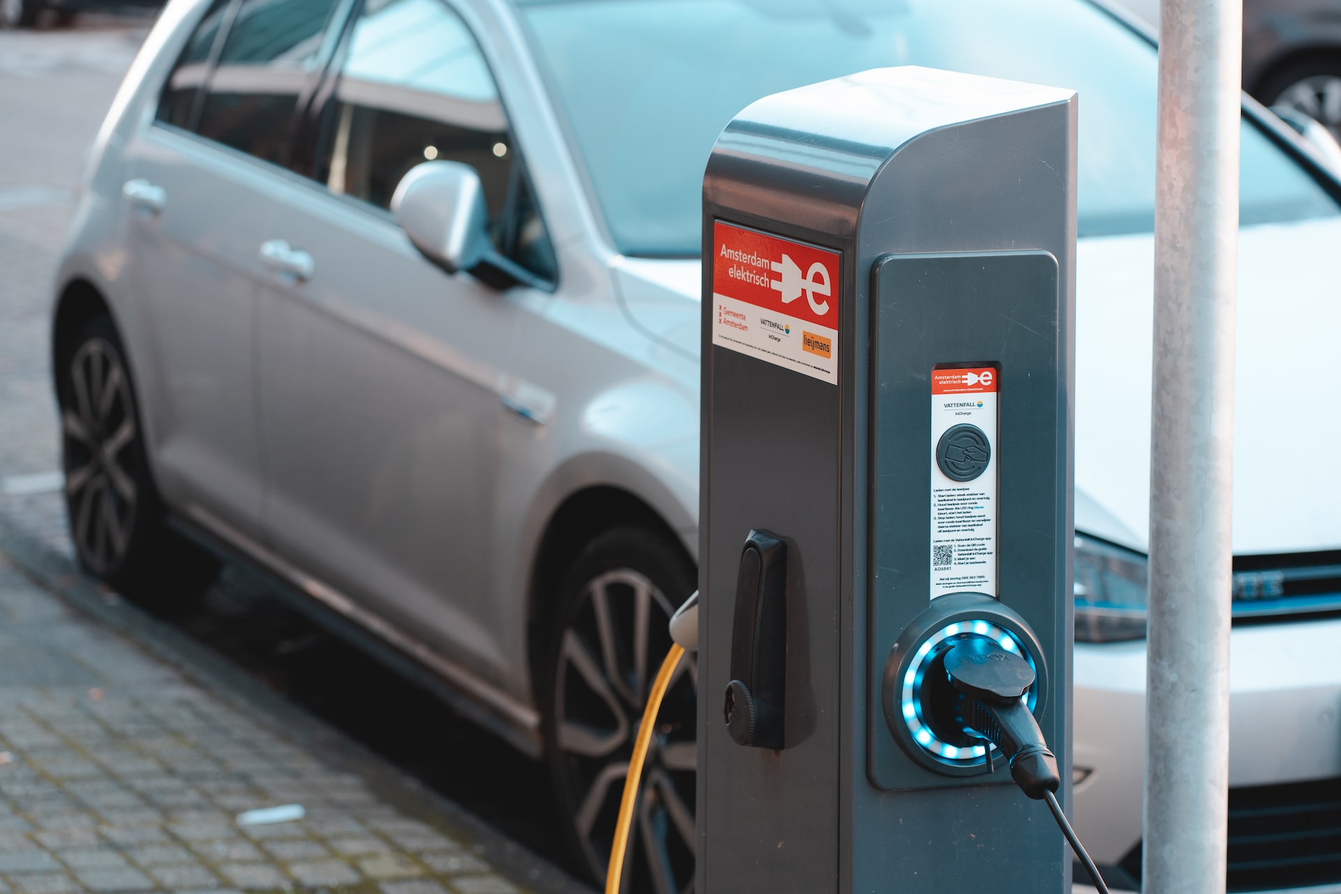 An electric car attached to a charging station